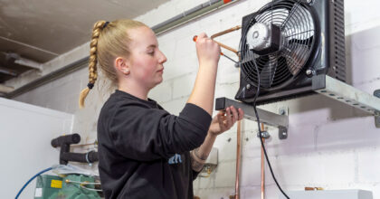 Eine Frau montiert eine Kältesystemanlage.