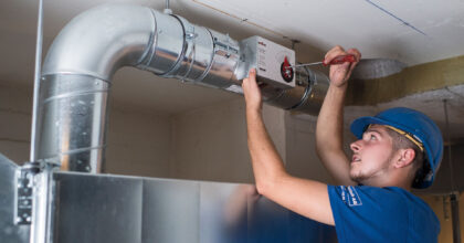 Ein Mann baut ein Lüftungsrohrsystem zusammen.