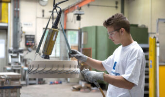 Ein Mann kontrolliert ein fertiges Gussteil.